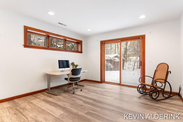 office area with light hardwood / wood-style floors