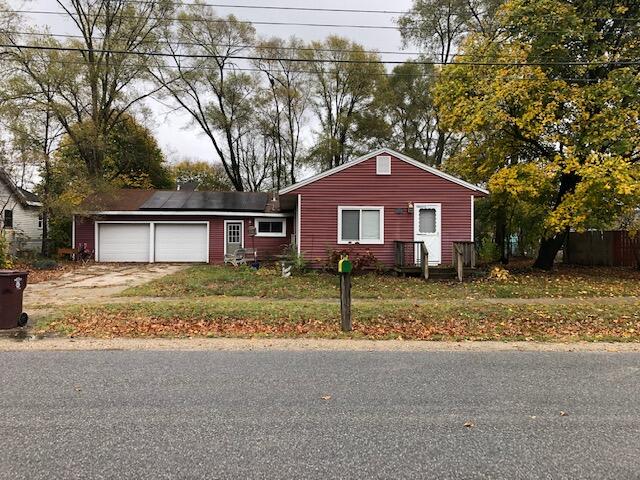 view of front of house with a garage and solar panels