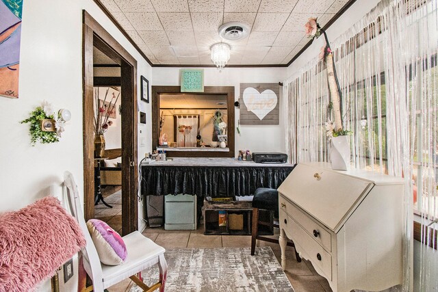 interior space featuring light tile patterned floors and ornamental molding