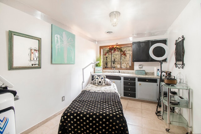 bedroom featuring light tile patterned floors and sink