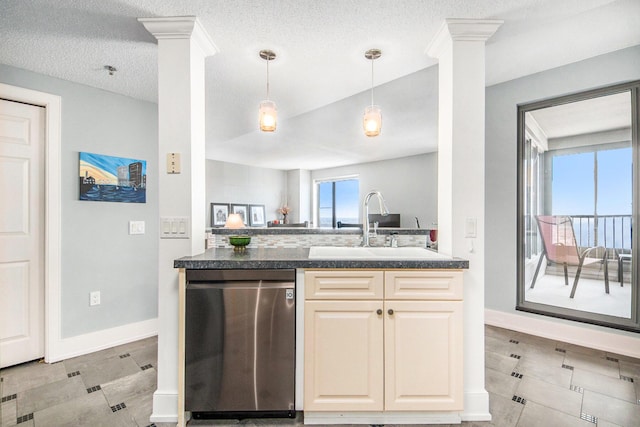 kitchen featuring a textured ceiling, decorative columns, stainless steel dishwasher, and sink