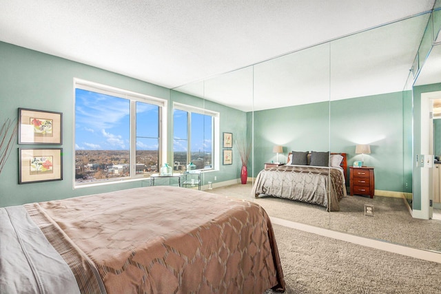 carpeted bedroom featuring a textured ceiling