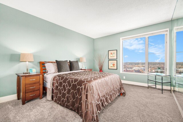 bedroom with light carpet and a textured ceiling