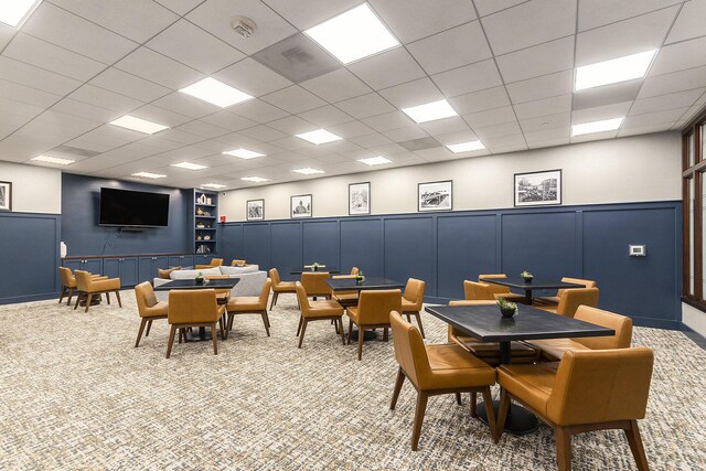 playroom with a paneled ceiling and carpet floors