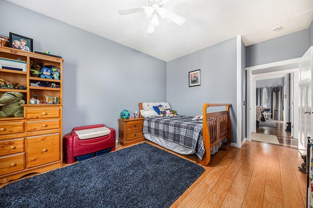 bedroom featuring hardwood / wood-style floors and ceiling fan