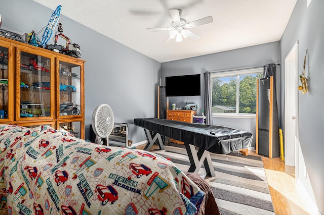 bedroom featuring light hardwood / wood-style floors and ceiling fan