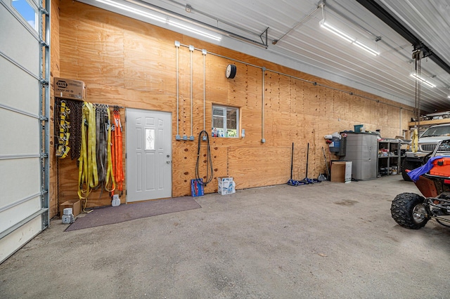 garage featuring wood walls