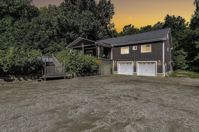 view of front of property featuring a garage and a wooden deck