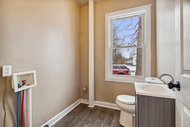 bathroom featuring wood-type flooring, vanity, and toilet