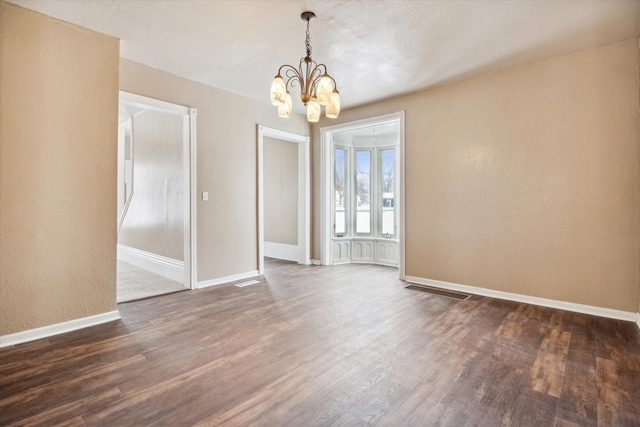 unfurnished dining area featuring dark hardwood / wood-style flooring and a notable chandelier