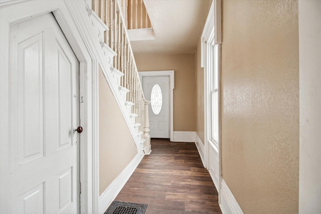 entryway with dark wood-type flooring