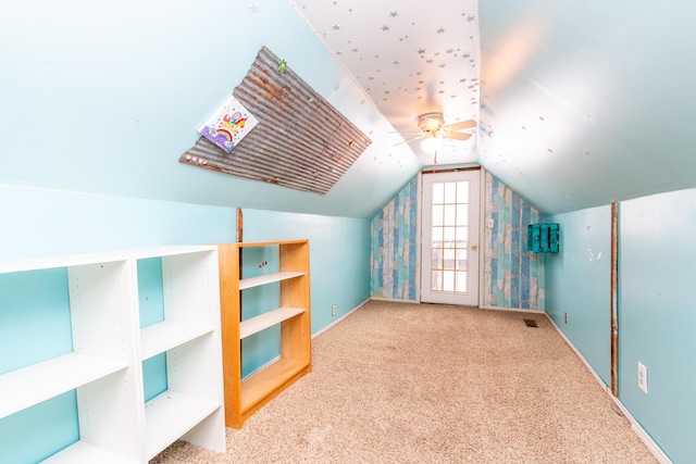 additional living space featuring carpet, vaulted ceiling, and ceiling fan