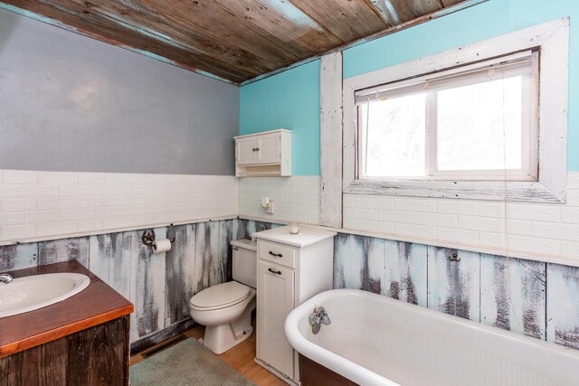 bathroom with wooden ceiling, wood-type flooring, toilet, a bathtub, and vanity