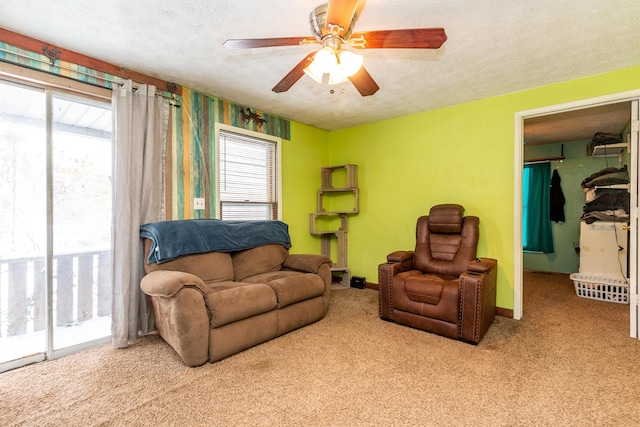 carpeted living room featuring a textured ceiling, a wealth of natural light, and ceiling fan