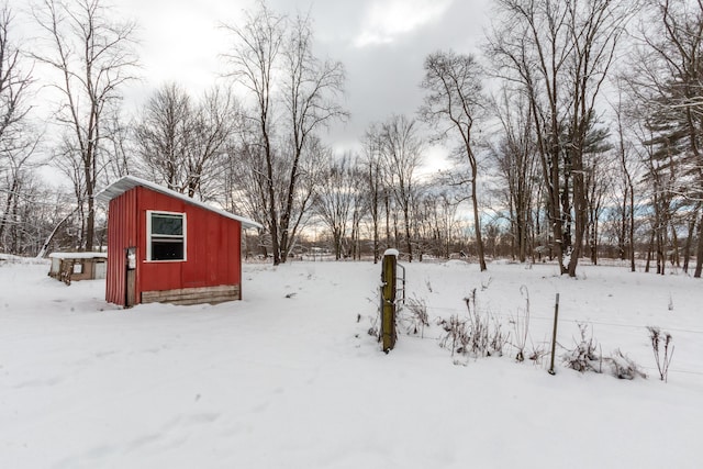 yard covered in snow featuring an outdoor structure