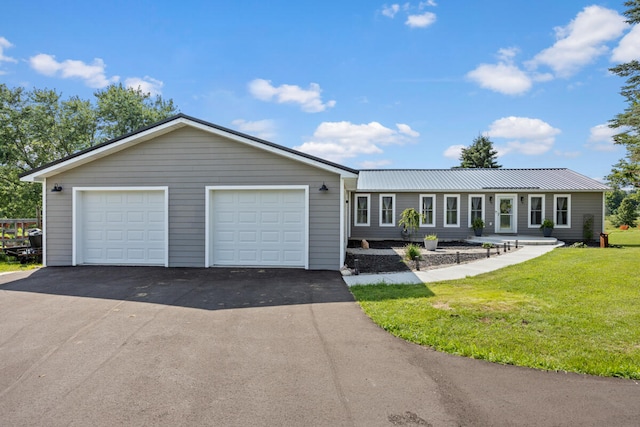 ranch-style house with a garage and a front lawn