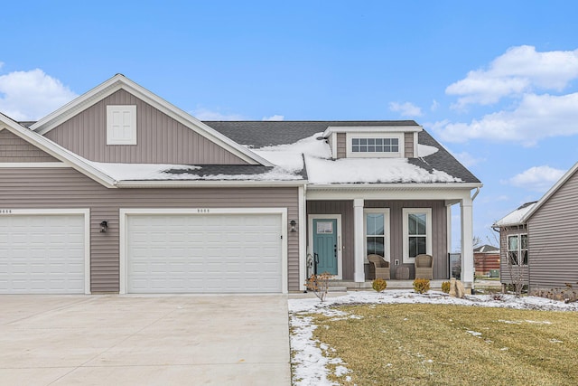 view of front of property featuring covered porch and a garage