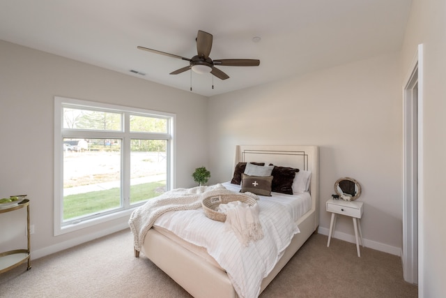 bedroom with light colored carpet and ceiling fan