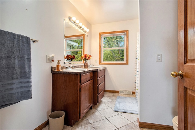 bathroom featuring tile patterned floors, vanity, and toilet