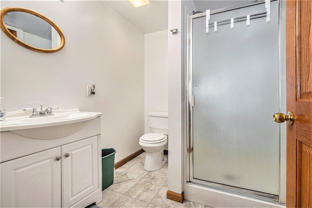 bathroom featuring vanity, toilet, and a shower with shower door