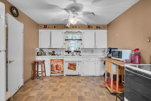 kitchen featuring white cabinetry, sink, ceiling fan, and white appliances