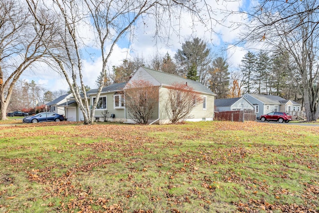 view of side of property featuring a yard and a garage