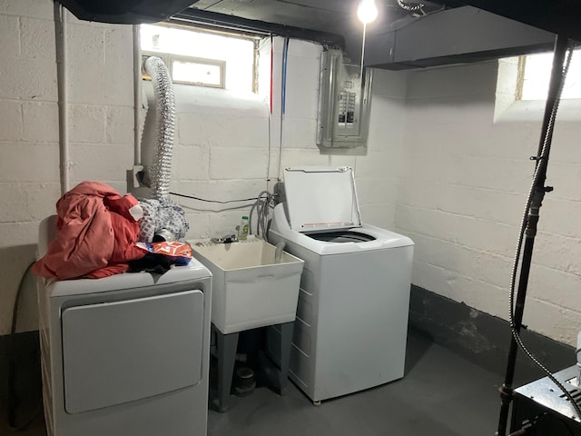 clothes washing area featuring a wealth of natural light, separate washer and dryer, sink, and electric panel