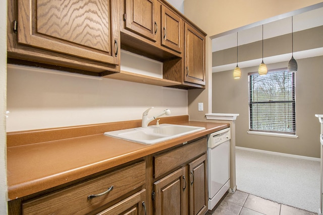 kitchen with dishwasher, light tile patterned floors, hanging light fixtures, and sink