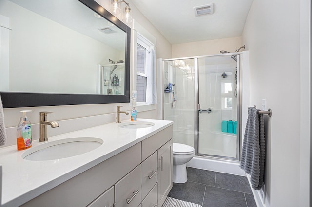 bathroom with vanity, tile patterned floors, toilet, and walk in shower