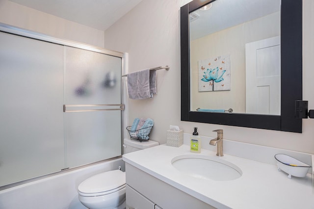 full bathroom with vanity, shower / bath combination with glass door, and toilet