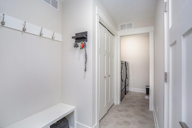 mudroom featuring washer and clothes dryer