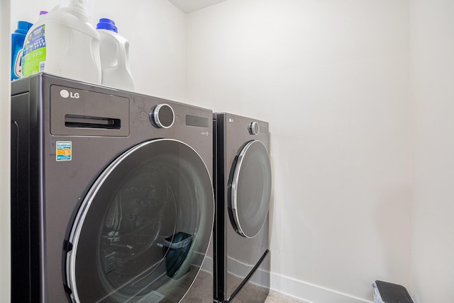 laundry area featuring tile patterned flooring and washer and dryer