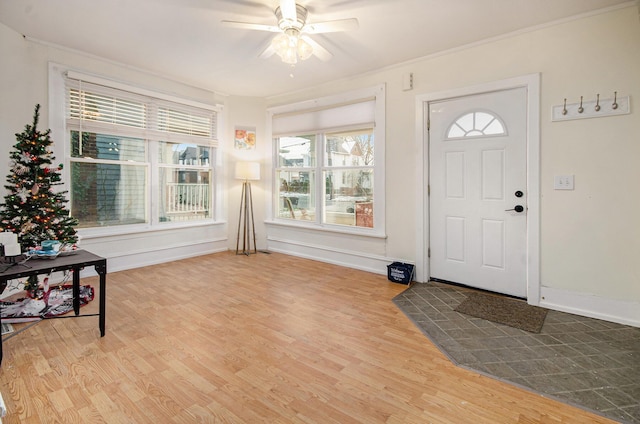 entryway with ceiling fan, hardwood / wood-style floors, and crown molding