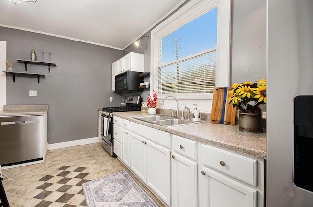 kitchen featuring sink, white cabinets, ornamental molding, and appliances with stainless steel finishes