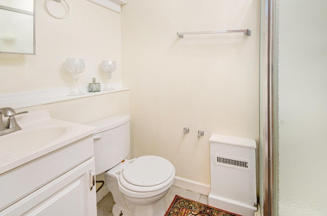 bathroom featuring tile patterned flooring, vanity, and toilet