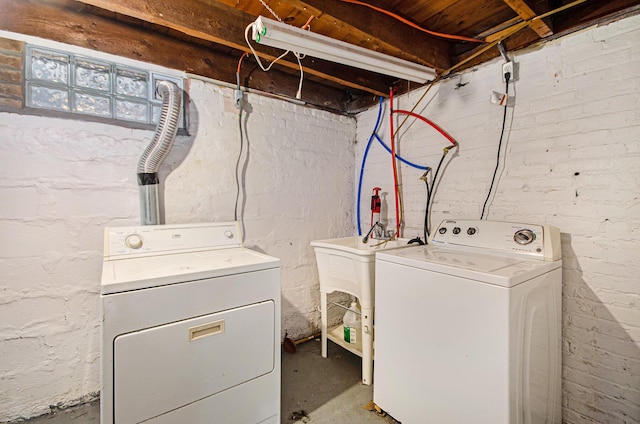 clothes washing area with washer and clothes dryer