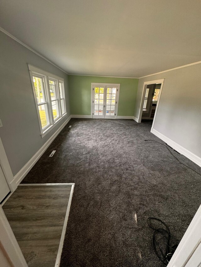 carpeted empty room featuring french doors and ornamental molding