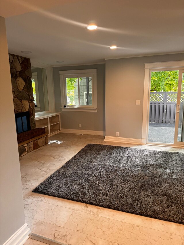 unfurnished living room with a fireplace and plenty of natural light