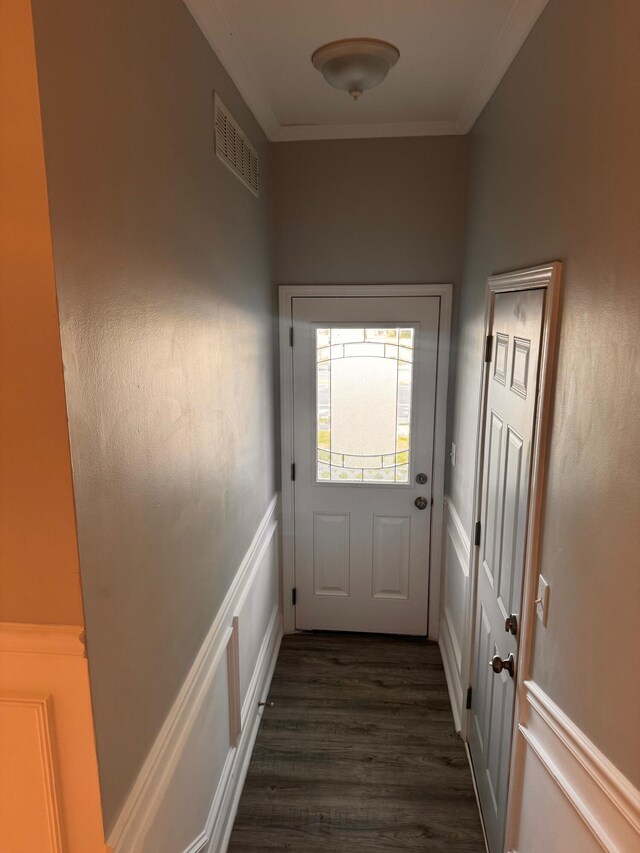 doorway with dark hardwood / wood-style floors and crown molding