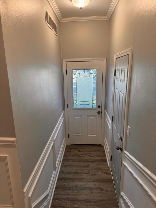 doorway with crown molding and dark wood-type flooring