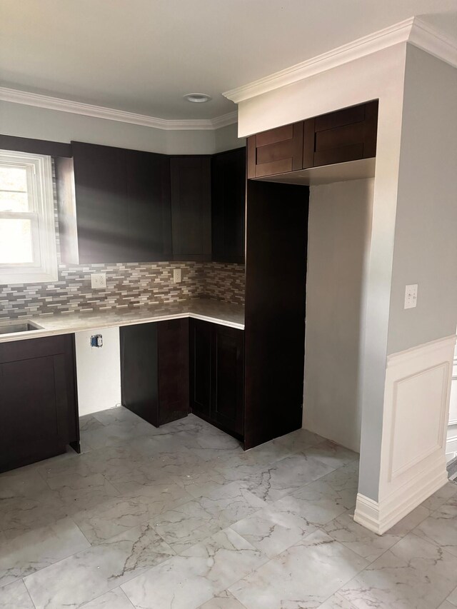 kitchen featuring crown molding and backsplash