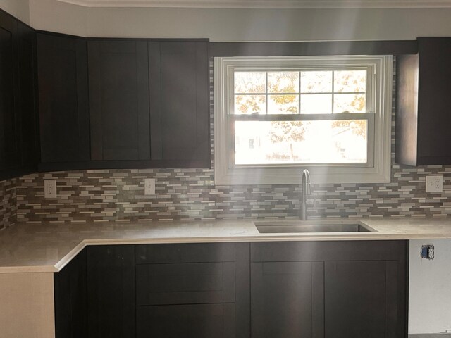 kitchen featuring decorative backsplash and sink