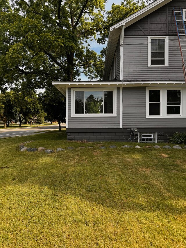 view of property exterior with a yard