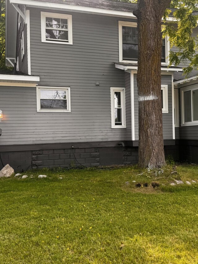 view of home's exterior with a lawn