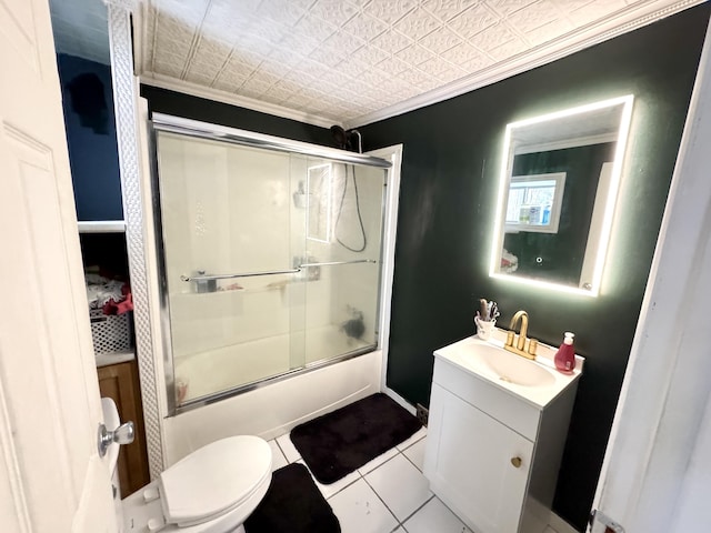 full bathroom featuring vanity, shower / bath combination with glass door, crown molding, tile patterned flooring, and toilet