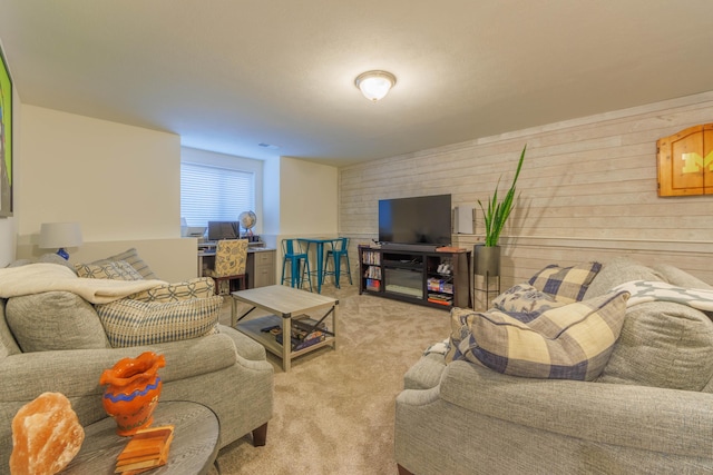 living room featuring wood walls and light carpet