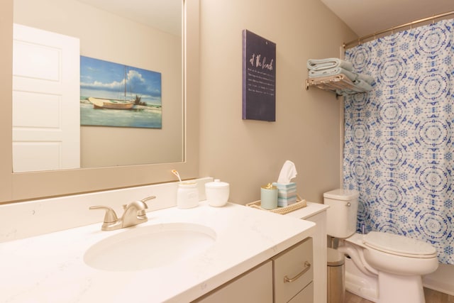 bathroom with a shower with shower curtain, vanity, and toilet