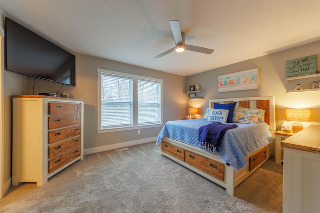 bedroom with ceiling fan and light carpet