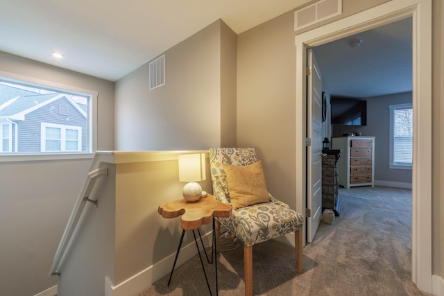 living area featuring carpet floors