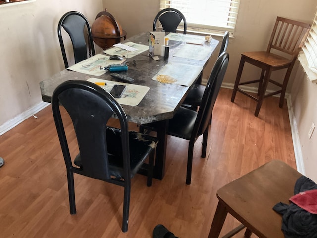 dining space with hardwood / wood-style flooring